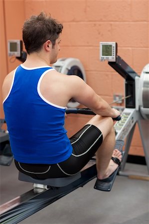 simsearch:400-04256139,k - Athletic caucasian man using a rower in a fitness center Stock Photo - Budget Royalty-Free & Subscription, Code: 400-04720186