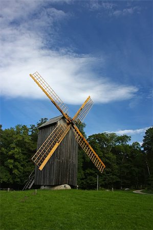 roxxer (artist) - Old example of an alternative energy generation - wooden windmill. Fotografie stock - Microstock e Abbonamento, Codice: 400-04720199