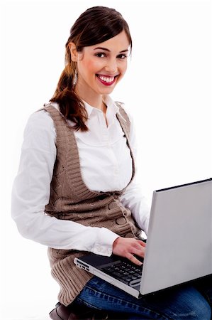 simsearch:400-05732500,k - Portrait of young lady sittng with laptop and working on it on an isolated background Foto de stock - Royalty-Free Super Valor e Assinatura, Número: 400-04720494