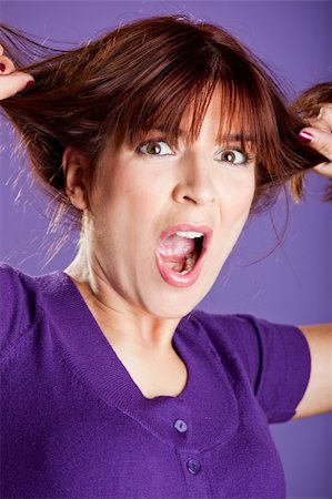 person screaming pulling hair - Beautiful woman with a angry expression pulling her hair Stock Photo - Budget Royalty-Free & Subscription, Code: 400-04721604