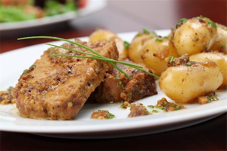 Roast pork on onion and mustard with baby potatoes Stock Photo - Budget Royalty-Free & Subscription, Code: 400-04721810