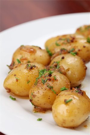 Roasted baby potatoes with onion, mustard seed and chives Stock Photo - Budget Royalty-Free & Subscription, Code: 400-04721812