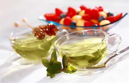 simsearch:400-06554630,k - Two cups of green herbal tea with sugar stick and fresh fruits Stock Photo - Budget Royalty-Free & Subscription, Code: 400-04722943