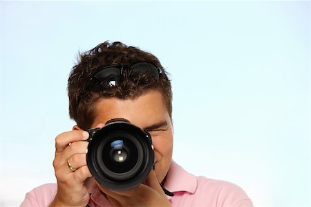 paparazzi taking pictures of man background - Young man with photo camera taking pictures Photographie de stock - Aubaine LD & Abonnement, Code: 400-04723608