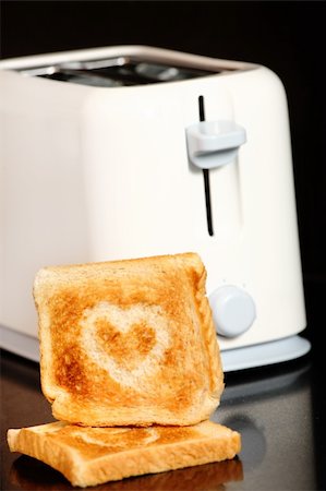 Toast with heart shape on it over toaster Stock Photo - Budget Royalty-Free & Subscription, Code: 400-04723697