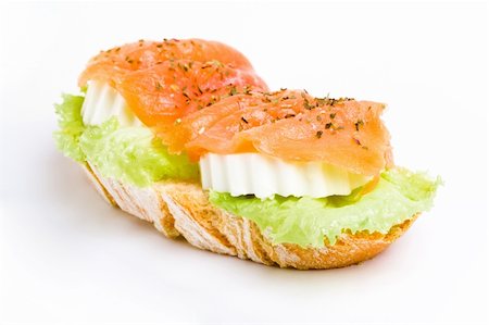 slice of french bread with lettuce and fresh cheese topped with sliced salmon. white background Foto de stock - Royalty-Free Super Valor e Assinatura, Número: 400-04734193