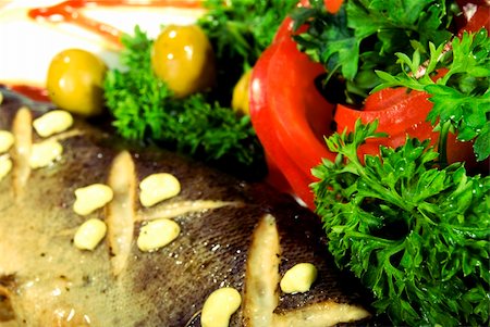 simsearch:400-04734276,k - Stuffed baked fish served with salad Photographie de stock - Aubaine LD & Abonnement, Code: 400-04734244