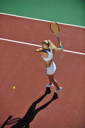 simsearch:400-06061549,k - young fit woman play tennis outdoor on orange tennis field at early morning Photographie de stock - Aubaine LD & Abonnement, Code: 400-04734608