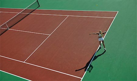 simsearch:400-06061549,k - young fit woman play tennis outdoor on orange tennis field at early morning Photographie de stock - Aubaine LD & Abonnement, Code: 400-04734601
