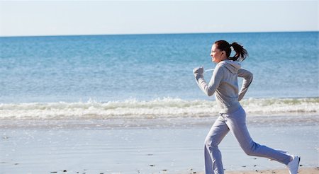 Attractive woman runnng on the beach Stock Photo - Budget Royalty-Free & Subscription, Code: 400-04734956