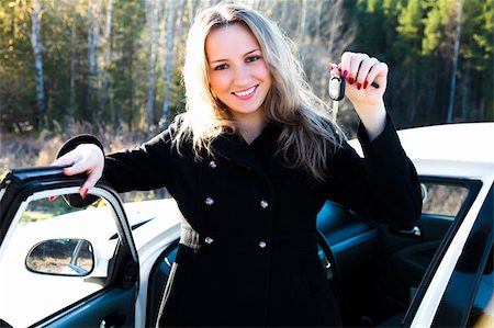 Happy owner of a new car showing a key. Stock Photo - Budget Royalty-Free & Subscription, Code: 400-04735045