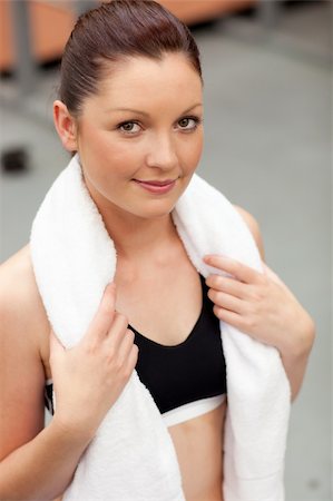 simsearch:400-05677914,k - Captivating athletic woman with towel around the neck smiling at the camera in a fitness center Stock Photo - Budget Royalty-Free & Subscription, Code: 400-04735430