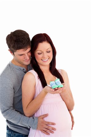 simsearch:400-04265188,k - young future parents looking at baby shoes against a white background Stock Photo - Budget Royalty-Free & Subscription, Code: 400-04735502