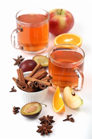 photo of apples in a white bowl - Spicy winter hot drink with oranges, apples, plums, cinnamon, anise and clove on white background Stock Photo - Budget Royalty-Free & Subscription, Code: 400-04736089