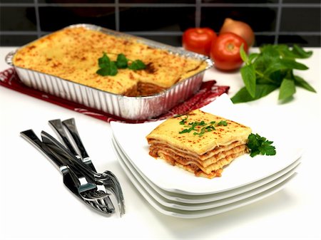 simsearch:400-08997151,k - A tray of lasagne on a kitchen bench being plated up Stock Photo - Budget Royalty-Free & Subscription, Code: 400-04736236