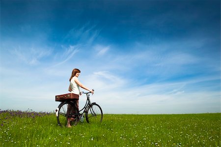 simsearch:400-04201795,k - Happy young woman on a green meadow with a vintage bicycle Fotografie stock - Microstock e Abbonamento, Codice: 400-04737445