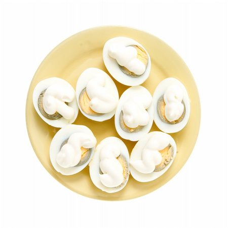 Eggs under mayonnaise on a yellow plate isolated on the white Foto de stock - Super Valor sin royalties y Suscripción, Código: 400-04737926