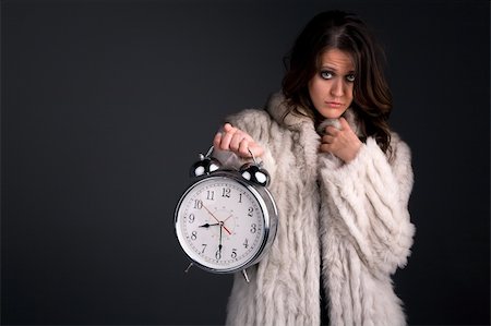 A beautiful woman is holding large alarm clock obviously upset at her companion. Stock Photo - Budget Royalty-Free & Subscription, Code: 400-04737965