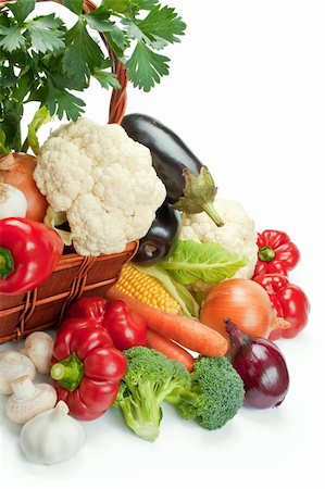 Mix of fresh ripe vegetables arranged in a wicker basket and around isolated on white background Stock Photo - Budget Royalty-Free & Subscription, Code: 400-04738226