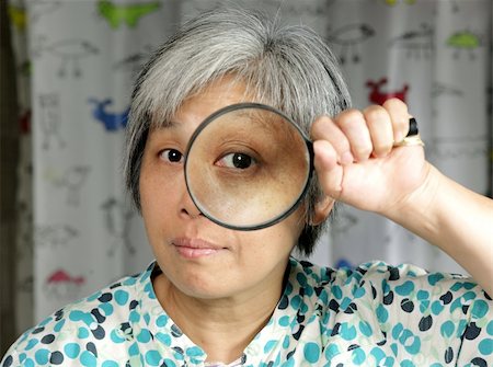 simsearch:400-04554899,k - woman holding magnifier Stock Photo - Budget Royalty-Free & Subscription, Code: 400-04739676