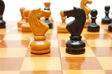 simsearch:400-04731518,k - White knight againts black one on vintage chess board Stock Photo - Budget Royalty-Free & Subscription, Code: 400-04731519