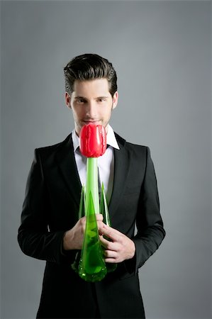 seduction tie - Businessman modern valentine plastic rose flower in hand over gray background Stock Photo - Budget Royalty-Free & Subscription, Code: 400-04731590