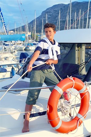 sailor and yacht - Boy teen sailor mooring boat rope in harbor summer marina standing up Stock Photo - Budget Royalty-Free & Subscription, Code: 400-04731608