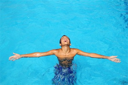 boy teenage relaxed open arms blue swimming pool summer vacations Stock Photo - Budget Royalty-Free & Subscription, Code: 400-04731600