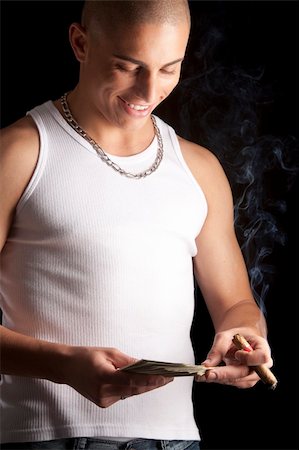 A good looking, muscular built, man on a black background smoking cigar. Stock Photo - Budget Royalty-Free & Subscription, Code: 400-04731785