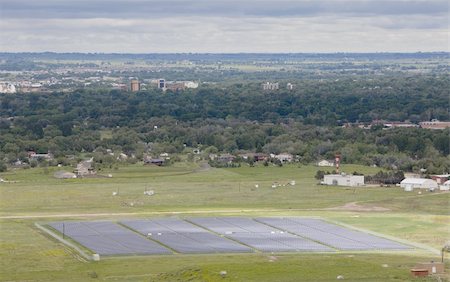 electricity city sun - large solar energy farm (3.3MW) at foothills campus of Colorado State University, aerial view from a mountain ridge with a hazy view of Fort Collins city on a partially cloudy day Stock Photo - Budget Royalty-Free & Subscription, Code: 400-04732648