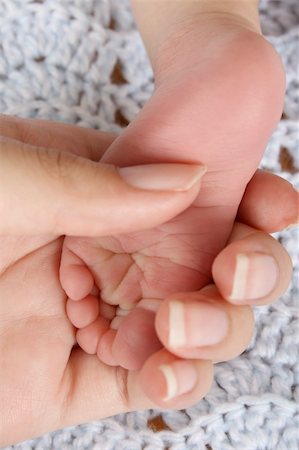 small soles - Mother holding foot of a newborn baby.  Focus on wrinkles on Foot. Stock Photo - Budget Royalty-Free & Subscription, Code: 400-04732680