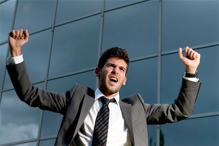 simsearch:400-04631810,k - Young successful businessman celebrating a goal on a modern building background Stock Photo - Budget Royalty-Free & Subscription, Code: 400-04732992