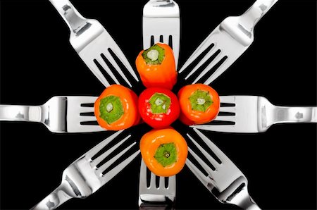 simsearch:695-05770339,k - Still-life of Colorful peppers and shiny silver forks isolated on a black background Stock Photo - Budget Royalty-Free & Subscription, Code: 400-04733155
