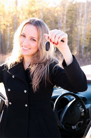 Happy owner of a new car showing a key. Stock Photo - Budget Royalty-Free & Subscription, Code: 400-04733391