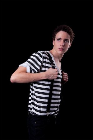 smart models male - Young confident man holding a trouser braces , isolated on black, studio shot Stock Photo - Budget Royalty-Free & Subscription, Code: 400-04744152