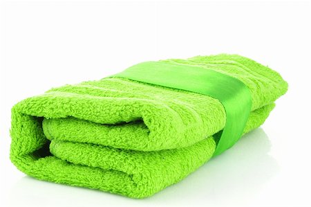 spa towel rolls - Folded green towel with the band isolated on white Stock Photo - Budget Royalty-Free & Subscription, Code: 400-04745367