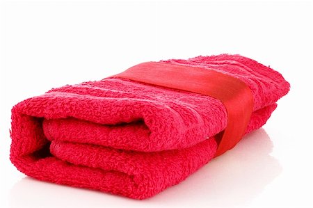 spa towel rolls - Folded red towel with the band isolated on white Stock Photo - Budget Royalty-Free & Subscription, Code: 400-04745372