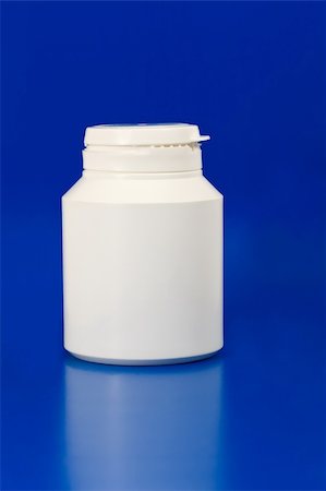 danilin (artist) - white plastic medicine container isolated on blue background Fotografie stock - Microstock e Abbonamento, Codice: 400-04745510