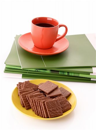 simsearch:400-04745852,k - Chocolate cookie and cup of coffee on magazines isolated on white Foto de stock - Royalty-Free Super Valor e Assinatura, Número: 400-04745848