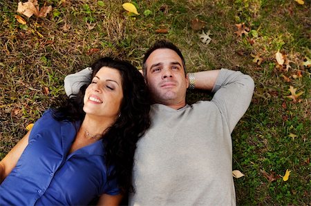 A couple laying on grass in a park daydreaming.  Focus on the womans eyes Stock Photo - Budget Royalty-Free & Subscription, Code: 400-04746309
