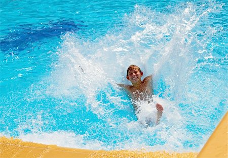 Young boy falls into the water with a waterslide Stock Photo - Budget Royalty-Free & Subscription, Code: 400-04746365