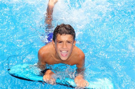 simsearch:400-04731600,k - boy teenager surfboard splashing blue water happy in sea pool Stock Photo - Budget Royalty-Free & Subscription, Code: 400-04746662