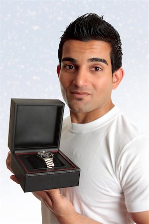 simsearch:400-04765778,k - An adult man showing  or holding up a watch or other product in a box. Stock Photo - Budget Royalty-Free & Subscription, Code: 400-04749078