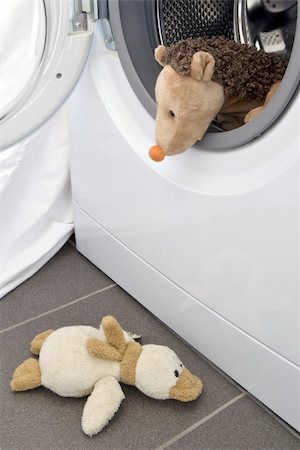 romeo und julia - A toy hedgehog sitting in the washing machine like a sailor on a ship, is watching his duck friend, down below. Stockbilder - Microstock & Abonnement, Bildnummer: 400-04749704