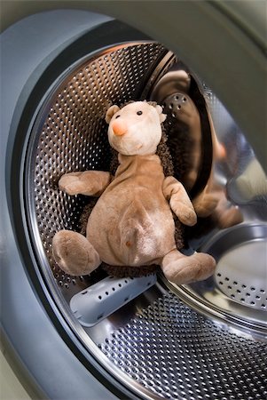 A toy hedgehog sitting inside the washing machine. Stock Photo - Budget Royalty-Free & Subscription, Code: 400-04749708