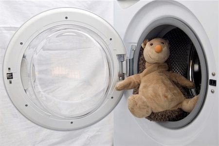 A toy hedgehog sitting in the washing machine like a sailor on a ship. Stock Photo - Budget Royalty-Free & Subscription, Code: 400-04749703