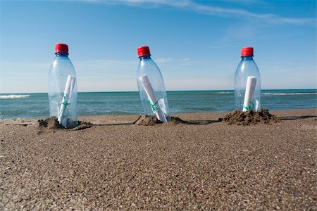 three messages in three plastic bottles Stock Photo - Budget Royalty-Free & Subscription, Code: 400-04749718