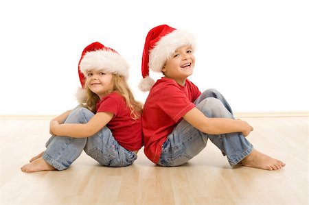 simsearch:400-07088886,k - Happy kids on the floor wearing christmas hats, laughing and having fun - isolated Stock Photo - Budget Royalty-Free & Subscription, Code: 400-04740154