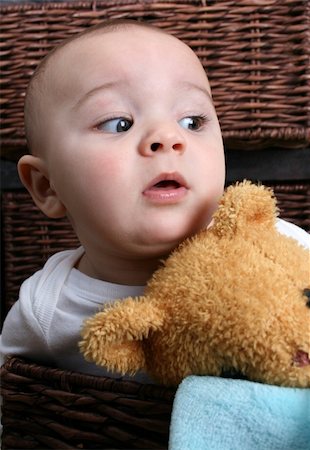 simsearch:400-05727835,k - Six month old baby sitting in front of wooden drawers Fotografie stock - Microstock e Abbonamento, Codice: 400-04740501