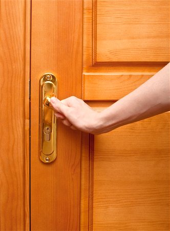 hand on a handle wooden door to open or close it Stock Photo - Budget Royalty-Free & Subscription, Code: 400-04741143